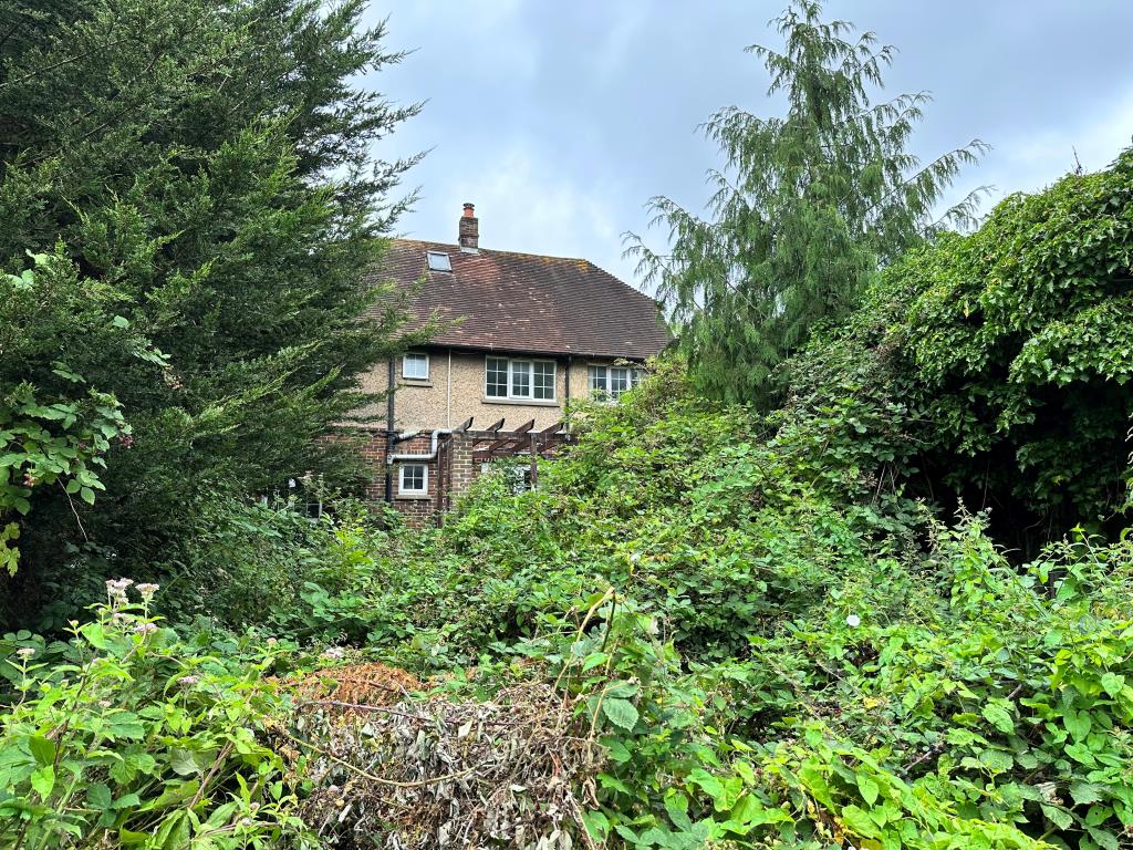 Lot: 136 - DETACHED HOUSE WITH GARAGE AND GARDENS IN NEED OF UPDATING - Overgrown garden to the rear